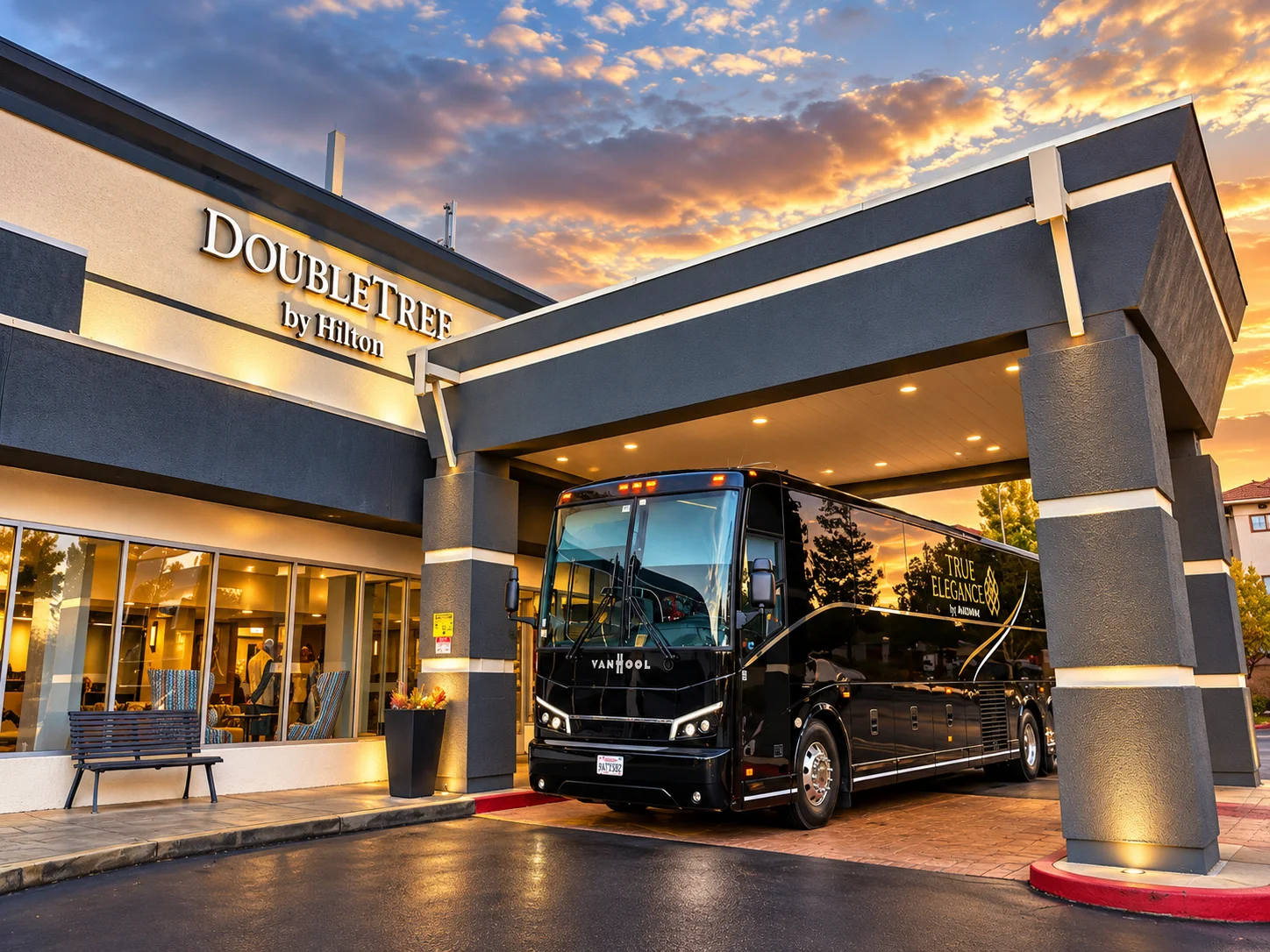 Bay Area charter bus hotel transportation Black True Elegance Van Hool motorcoach at a DoubleTree by Hilton hotel entrance