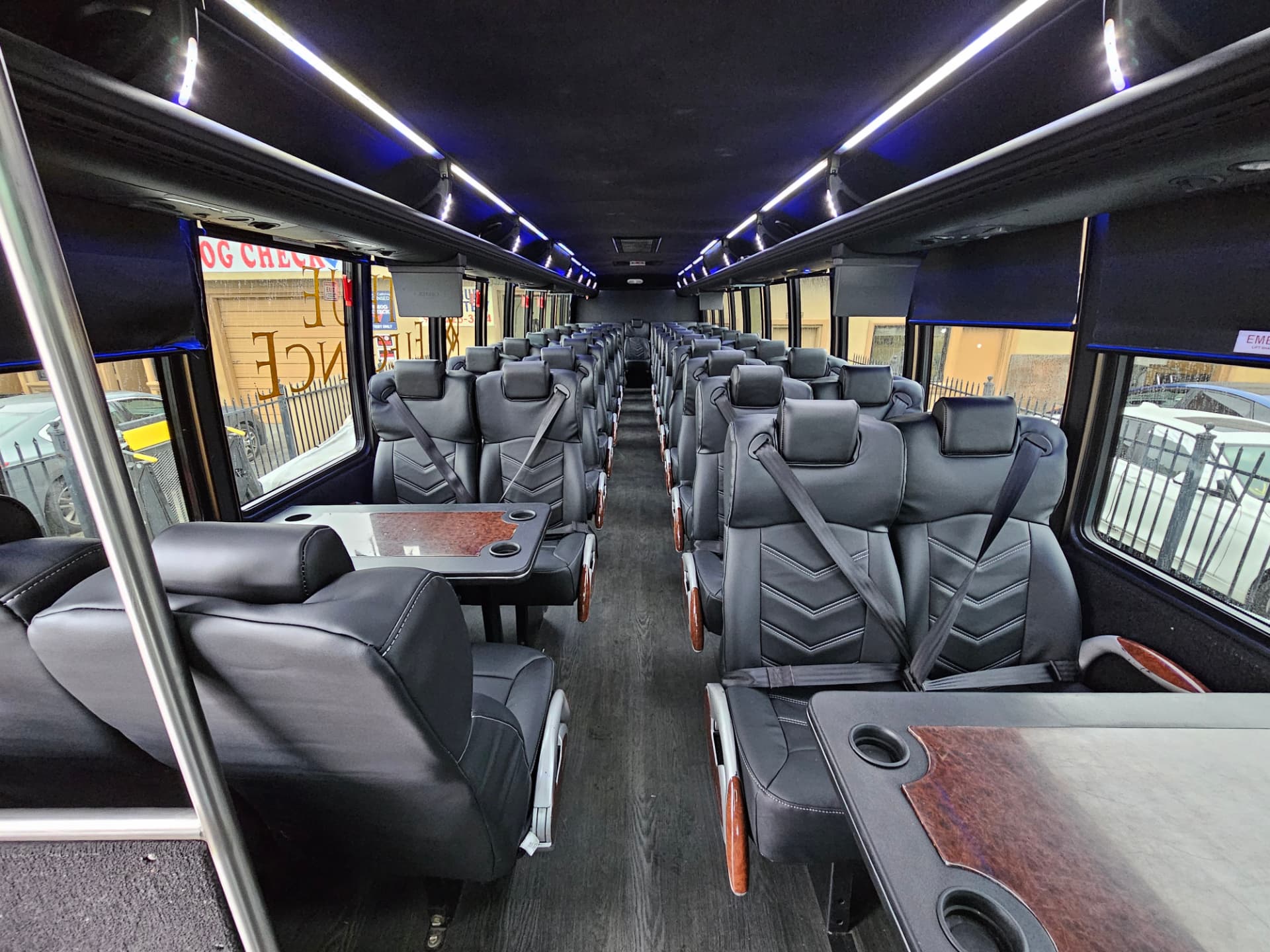 Executive coach interior Executive coach interior with black leather seats, wood conference tables and blue ceiling lighting