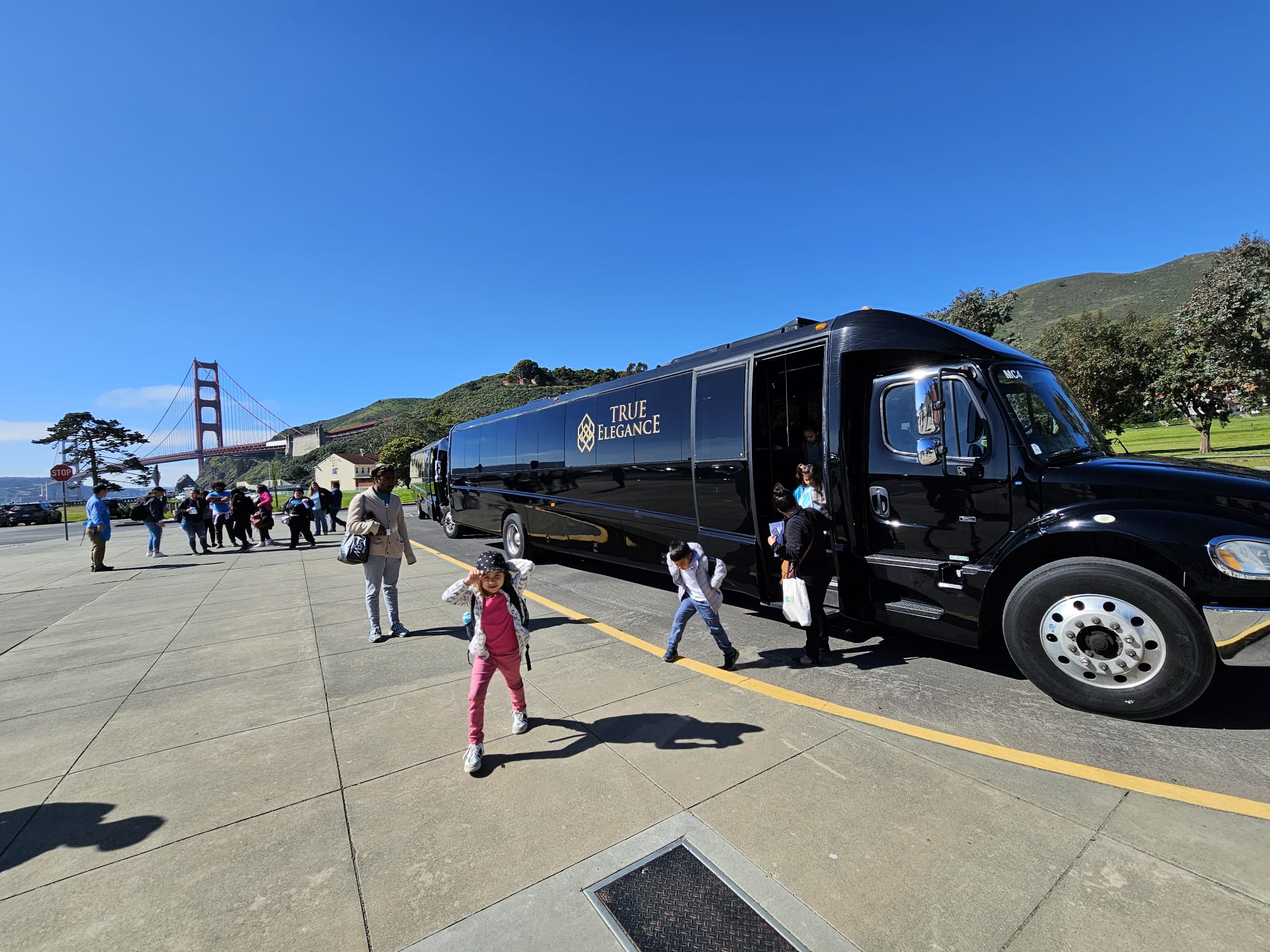 School field trip charter bus Students and chaperones unloading from a True Elegance charter bus during a school field trip