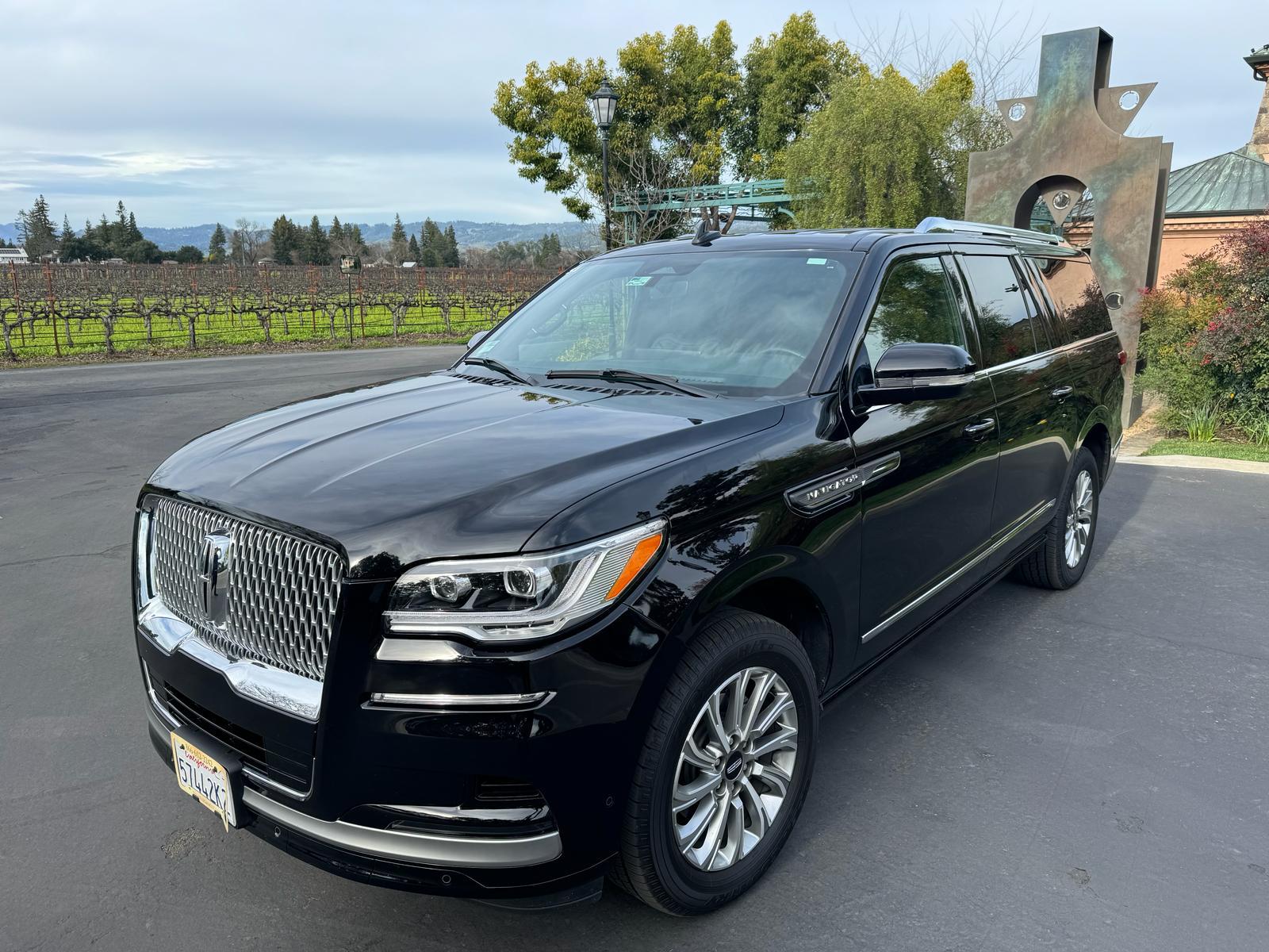 Lincoln Navigator luxury SUV Black Lincoln Navigator luxury SUV at a winery entrance with vineyard rows behind it