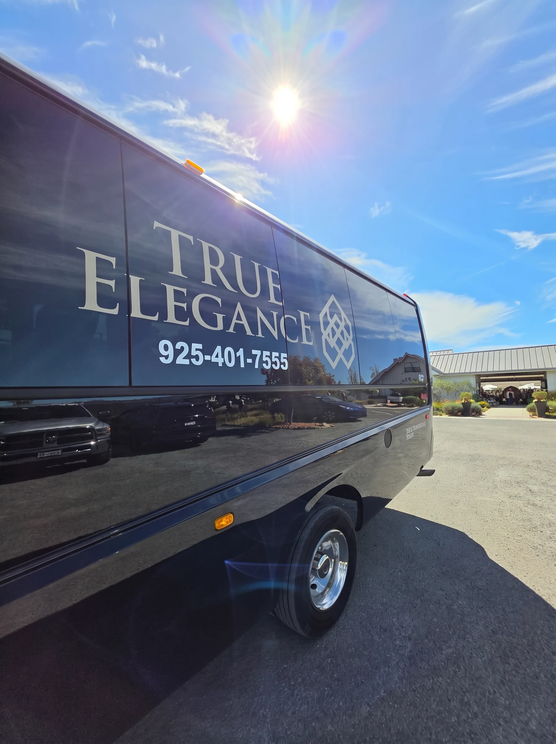 True Elegance executive shuttle True Elegance executive shuttle bus detail showing the company name and Pleasanton contact number